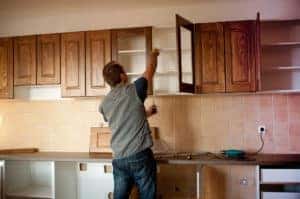 Kitchen contractor hanging new upper cabinets