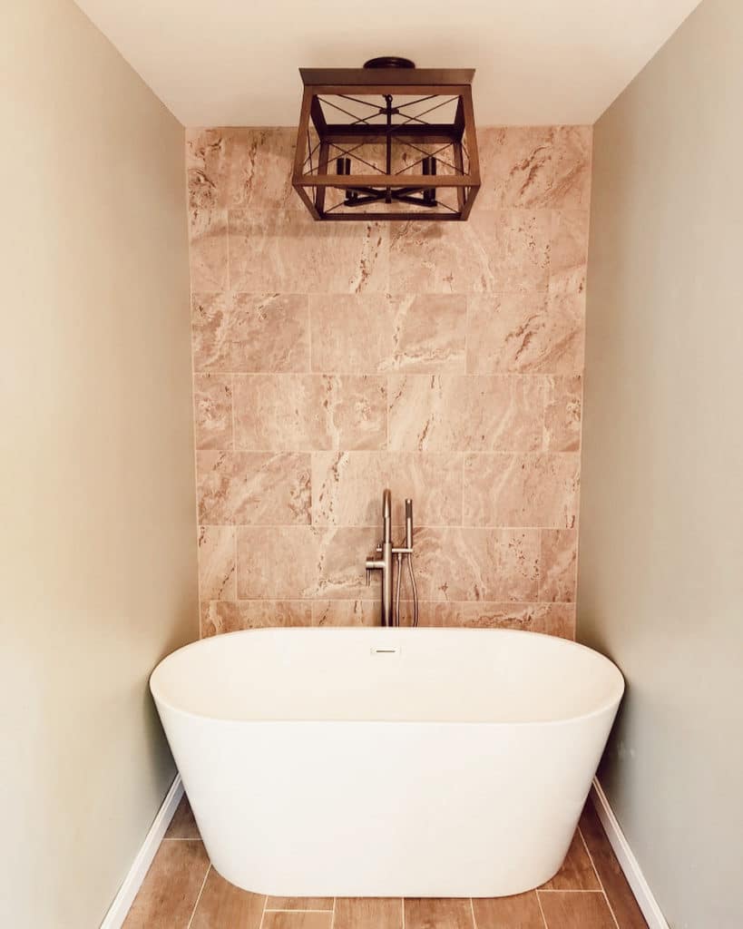 modern bathtub remodel with full wall tile