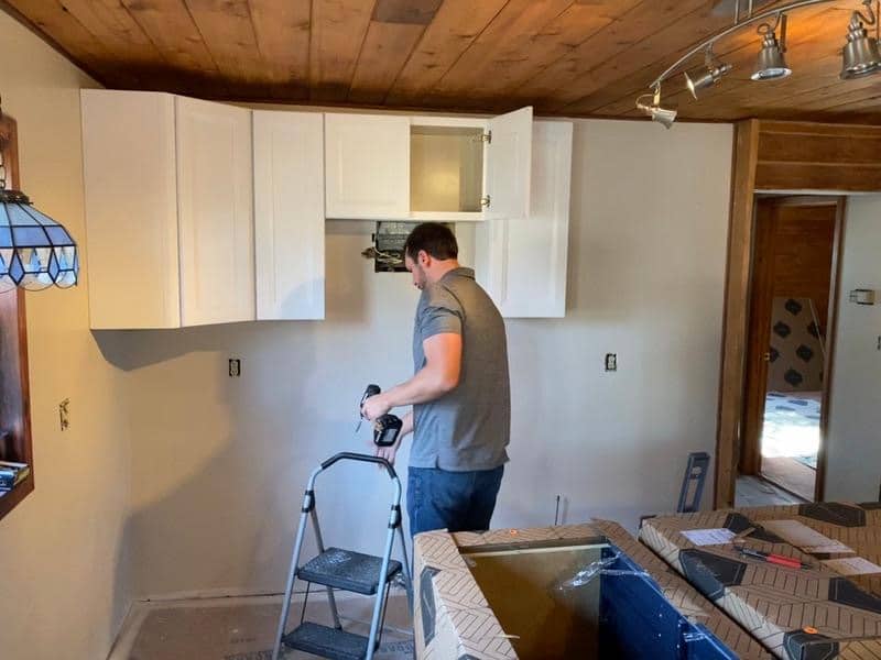 Greg of Explore Kitchens installing kitchen cabinets